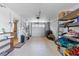 Spacious garage with shelving and plenty of room for storage or parking at 830 County Rd 457, Lake Panasoffkee, FL 33538