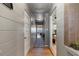 Hallway with wood-look floors leading to the living spaces and bedrooms at 830 County Rd 457, Lake Panasoffkee, FL 33538