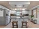 Bright kitchen with white cabinets, stainless steel appliances, and a central island with seating at 830 County Rd 457, Lake Panasoffkee, FL 33538