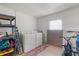 Laundry room features a large window, washer, dryer, and storage shelves at 830 County Rd 457, Lake Panasoffkee, FL 33538
