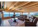 Open-concept living room with lake views, a brick fireplace, and comfortable seating at 830 County Rd 457, Lake Panasoffkee, FL 33538