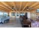 Bright and airy living room with wood-paneled walls, lake views, and comfortable seating at 830 County Rd 457, Lake Panasoffkee, FL 33538