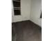 Simple bedroom with dark carpet, light walls, and a window offers a blank slate for customization at 102 Se 6Th Ave, Mulberry, FL 33860