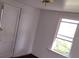 Bright bedroom features a window, neutral walls, and ample space for furnishings, offering room for customization at 102 Se 6Th Ave, Mulberry, FL 33860