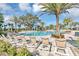 Resort-style community pool with palm trees, lounge chairs, and a splash pad for luxurious outdoor living at 1906 Clear Sky Dr, Kissimmee, FL 34744