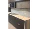 Elegant kitchen featuring modern gray cabinetry, quartz countertops, and stainless steel microwave at 254 Chelsea Ave, Davenport, FL 33837