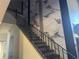 A modern staircase with elegant marble-style wall accents and wrought iron railings, creating a luxurious and stylish entryway at 254 Chelsea Ave, Davenport, FL 33837