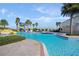 A large, sparkling community pool is surrounded by palm trees, lounge chairs and a slide to provide a resort-like oasis at 5345 Dagenham Dr, Davenport, FL 33837
