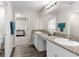 Bright bathroom with double sinks, granite countertops, and walk-in closet view at 1532 Axel Cir, Winter Haven, FL 33880