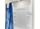 Bathroom featuring a sleek, white shower with built-in shelving and a vibrant shower curtain at 1532 Axel Cir, Winter Haven, FL 33880