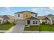 Beautiful two-story home featuring colorful exterior paint, attached garage, and a well-manicured front lawn at 1532 Axel Cir, Winter Haven, FL 33880