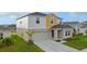 Charming two-story home with a well-manicured lawn, attached garage, and inviting front entrance at 1532 Axel Cir, Winter Haven, FL 33880