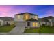 Charming two-story home showcasing colorful exterior paint, attached garage, and well-maintained landscaping at 1532 Axel Cir, Winter Haven, FL 33880