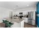 Well-appointed kitchen featuring stainless steel appliances, granite countertops, a center island, and bar stool seating at 1532 Axel Cir, Winter Haven, FL 33880