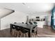Open-concept dining and kitchen area featuring modern appliances, granite countertops, and wood flooring at 1532 Axel Cir, Winter Haven, FL 33880