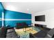 Bright living room featuring an attractive blue accent wall, contemporary furniture, and stylish decor at 1532 Axel Cir, Winter Haven, FL 33880