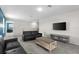 Inviting living room with gray carpet and comfortable black sofas at 1532 Axel Cir, Winter Haven, FL 33880