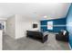 Spacious living room featuring a modern sofa, wall-mounted TV, and contemporary decor at 1532 Axel Cir, Winter Haven, FL 33880