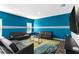 Inviting living room with a bold blue accent wall, modern furniture, and a comfortable seating arrangement at 1532 Axel Cir, Winter Haven, FL 33880