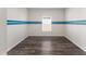 Bright room featuring stylish gray wood flooring and a blue stripe accent wall at 1532 Axel Cir, Winter Haven, FL 33880