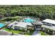 Aerial view showcases a resort-style community pool and clubhouse with lush landscaping at 4658 Yellow Elder Way, Kissimmee, FL 34758