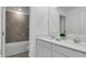 Modern bathroom featuring double sinks, white cabinets, and a tiled shower-tub combination at 5618 Gingham Dr, Kissimmee, FL 34758
