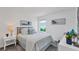 Bright bedroom features a cozy bed, soft gray carpet, and artwork on the white walls at 5618 Gingham Dr, Kissimmee, FL 34758