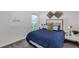 Cozy bedroom featuring a comfortable bed, a nightstand, and modern wall decor at 5618 Gingham Dr, Kissimmee, FL 34758
