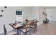Bright dining room featuring a wood table set for six, tile flooring, and modern decor at 5618 Gingham Dr, Kissimmee, FL 34758