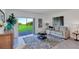 Inviting living room with a cozy couch, stylish rug, and sliding glass doors to the outdoors at 5618 Gingham Dr, Kissimmee, FL 34758