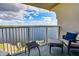 Relaxing condo balcony with seating, lake view, and blue sky at 13415 Blue Heron Beach Dr # 1201, Orlando, FL 32821