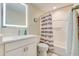Bathroom displays a white vanity, a sink, a toilet, a shower-tub combo with modern fixtures at 13415 Blue Heron Beach Dr # 1201, Orlando, FL 32821