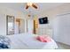 Bedroom boasts a TV, an ensuite bathroom, closet space, and tasteful decor for comfortable living at 13415 Blue Heron Beach Dr # 1201, Orlando, FL 32821