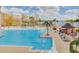Large community pool with poolside bar, lounge chairs, and lake view at 13415 Blue Heron Beach Dr # 1201, Orlando, FL 32821