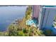 Poolside view highlighting lush landscaping and serene waterfront location of condo complex at 13415 Blue Heron Beach Dr # 1201, Orlando, FL 32821