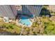 Overhead shot of a large outdoor swimming pool, surrounded by lush greenery and lounge chairs at 13415 Blue Heron Beach Dr # 1201, Orlando, FL 32821