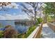 Scenic walkway leading to a community dock with lakeside gazebo at 13415 Blue Heron Beach Dr # 1201, Orlando, FL 32821
