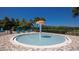 A splash pad featuring a center mushroom fountain, lounge chairs, and green landscaping at 4694 Yellow Elder Way, Kissimmee, FL 34758