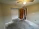 View of the bedroom with standard closet, ceiling fan, and paint ready for customization at 669 Eagle Run, Lakeland, FL 33809