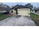 Charming single-story home with an attached garage and well-maintained front yard at 669 Eagle Run, Lakeland, FL 33809
