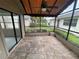 Relaxing screened patio with ceiling fan and brick flooring, perfect for outdoor entertaining at 669 Eagle Run, Lakeland, FL 33809