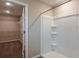 Bathroom with shower and walk-in closet with shelving for optimal storage at 1014 Foreshore Ln, Haines City, FL 33844