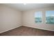 This bedroom features neutral walls, plush carpeting, and two windows for ample natural light at 1014 Foreshore Ln, Haines City, FL 33844