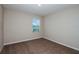 Neutral bedroom with a large window providing natural light and plush carpeting at 1014 Foreshore Ln, Haines City, FL 33844