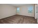 Bedroom features carpet, neutral walls, and bright windows allowing for ample natural light at 1014 Foreshore Ln, Haines City, FL 33844