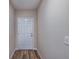 Hallway featuring wood floors and white door at 1014 Foreshore Ln, Haines City, FL 33844