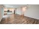 Open-concept living space with kitchen, wood-look floors, neutral walls, and a staircase at 1014 Foreshore Ln, Haines City, FL 33844
