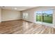 Spacious living room with wood-look floors, neutral walls, large windows, and sliding glass doors to the backyard at 1014 Foreshore Ln, Haines City, FL 33844