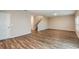 Spacious living room with wood-look floors, neutral walls, a staircase, and a door to the outside at 1014 Foreshore Ln, Haines City, FL 33844