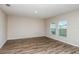 A well-lit living room features durable wood-style flooring and two bright windows at 1014 Foreshore Ln, Haines City, FL 33844